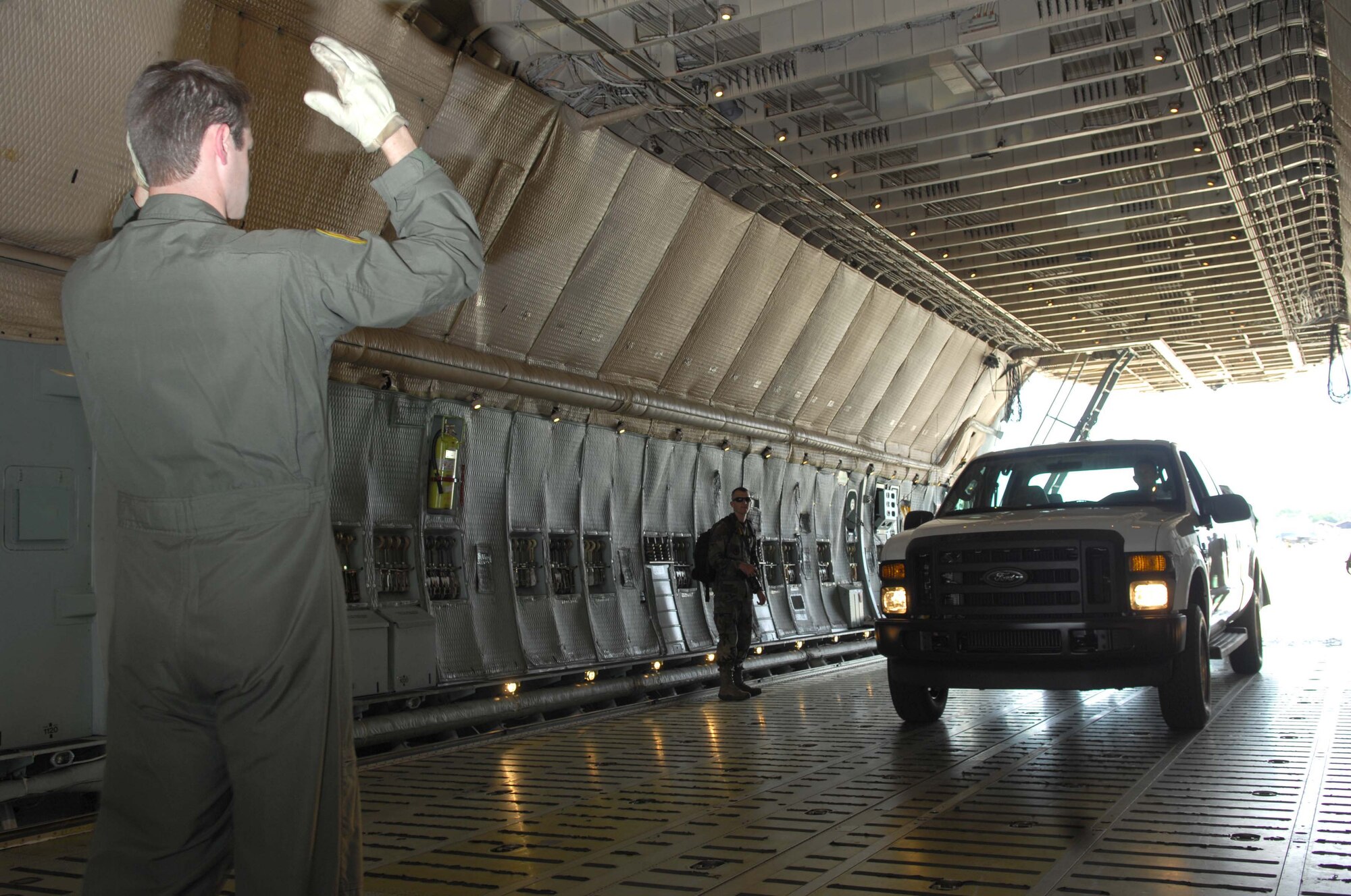 SHAW AIR FORCE BASE, S.C.--  Tech. Sgt. Jon Menad from the 337th Airlift Squadron at Westover Air Reserve Base, Mass., transports equipment for the 77th Fighter Squadron deployment May 22. More than 200 Airmen and a dozen F-16s from the 20th Fighter Wing deployed to Southwest Asia to support the Global War on Terrorism. (U.S. Air Force photo/Senior Airman William Coleman)