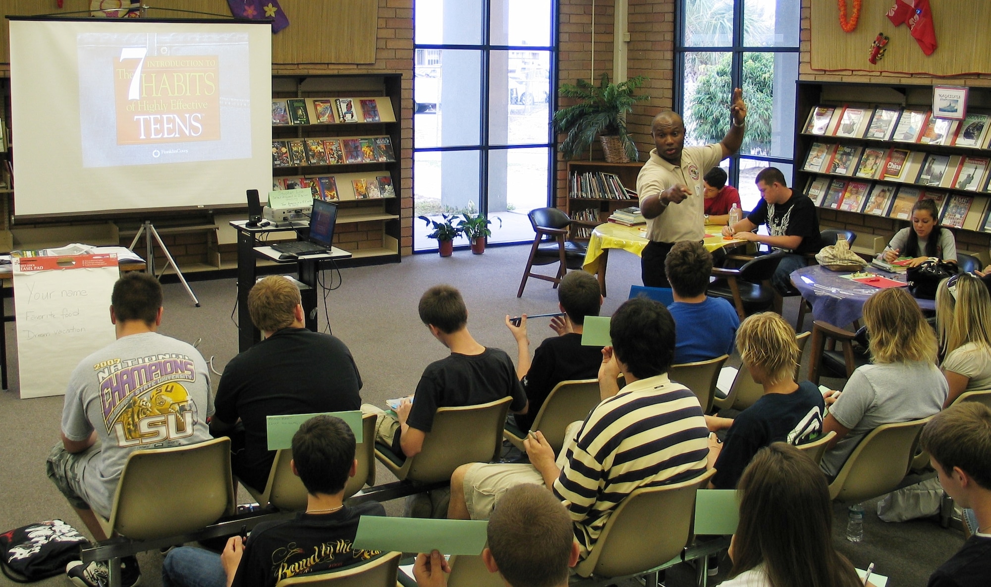 Master Sgt. Stephen Love from the Patrick Air Force Base Equal Opportunity Office (standing in tan shirt) speaks to students from Satellite High School May 19. (U.S. Air Force photo by Airman 1st Class David Dobrydney)