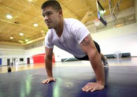 5/12/2008 - Airman 1st Class Daniel Kuertz knocks out pushups during his physical training session. Airman Kuertz lost 120 pounds in a year-and-a-half in order to enlist in the Air Force. (USAF photo by Robbin Cresswell)