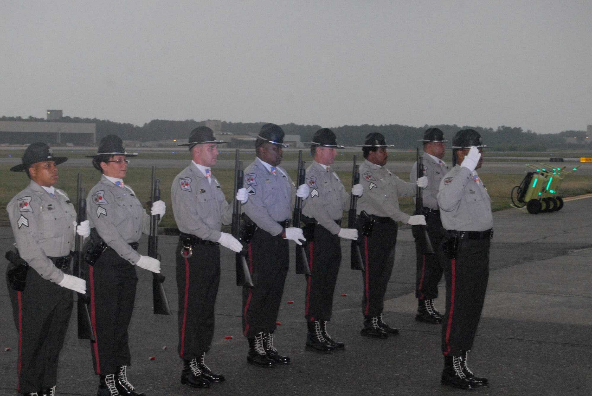 Members from the Cumberland County Sheriff's Department Honor Guard team present arms during Taps following a 21-gun salute during the National Law Enforcement Memorial Ceremony May 15 in Hangar 4 here. (U.S. Air Force Photo by Staff Sgt. Jon LaDue)