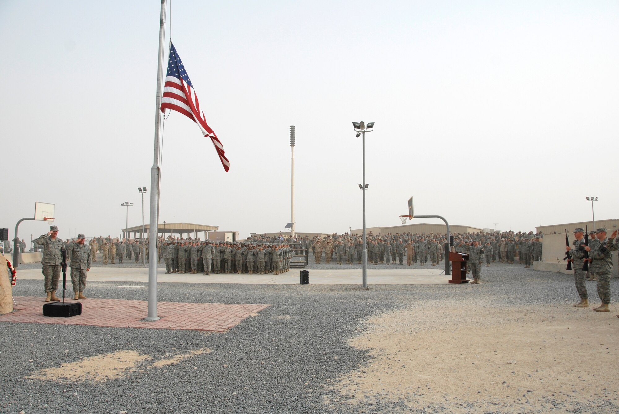 SOUTHWEST ASIA -- Airmen deployed to the 386th Air Expeditionary Wing render a salute while taps is playing during a Memorial Day ceremony May 26, 2008 at an air base in the Persian Gulf Region. During the ceremony, a 21-gun salute was conducted along with a laying of a wreath to honor the men and women who have died in military service. (U.S. Air Force photo/ Staff Sgt. Patrick Dixon)