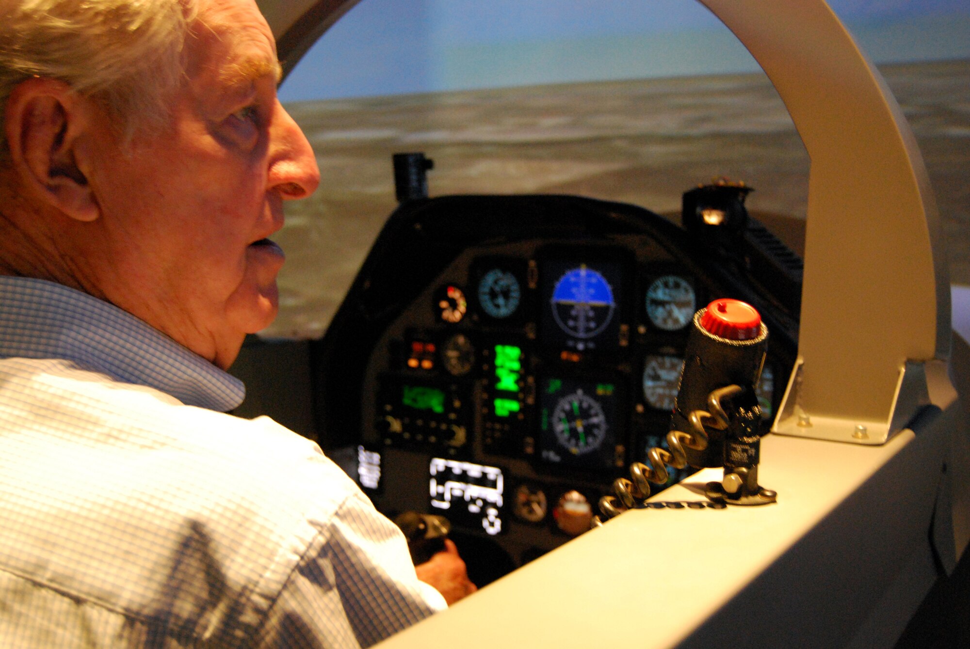 Retired Air Force Lt. Col. Bill Peel, a veteran of World War II and the Korean and Vietnam wars, works to get his bearings May 23 during a T-6A Texan II flight simulator ride at Sheppard Air Force Base. Mr. Peel was treated to a ride during his visit to the 80th Flying Training Wing, but his thoughts are with his fallen comrades killed during each war in which he served. (U.S. Air Force photo/John Ingle)