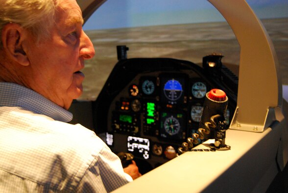 Retired Air Force Lt. Col. Bill Peel, a veteran of World War II and the Korean and Vietnam wars, works to get his bearings May 23 during a T-6A Texan II flight simulator ride at Sheppard Air Force Base. Mr. Peel was treated to a ride during his visit to the 80th Flying Training Wing, but his thoughts are with his fallen comrades killed during each war in which he served. (U.S. Air Force photo/John Ingle)