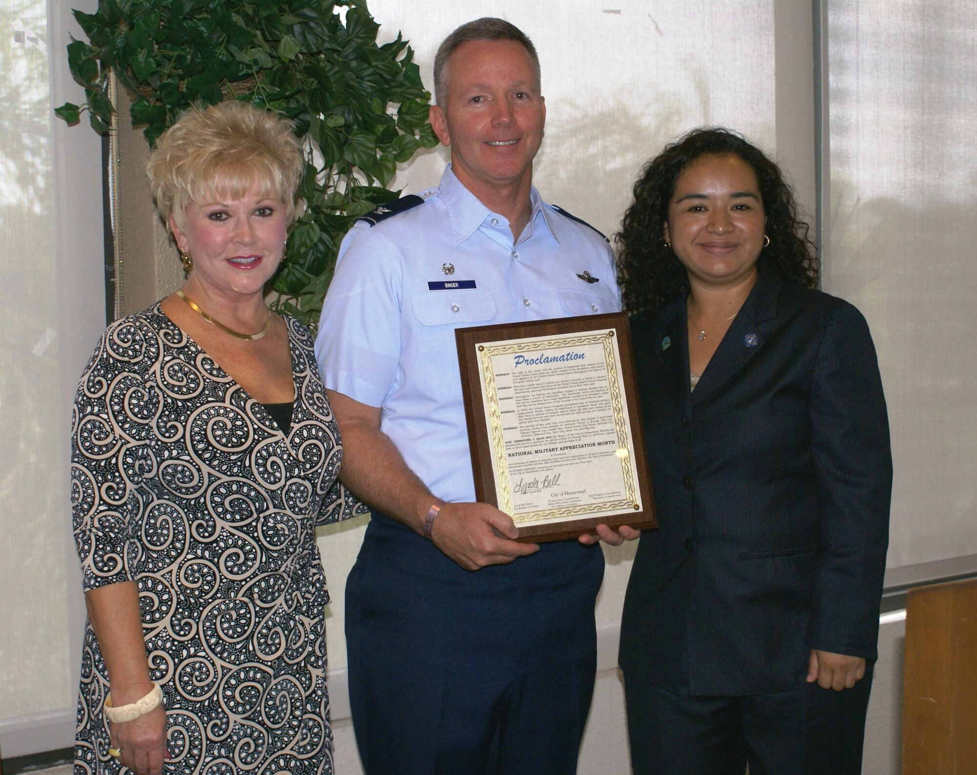Col. William Binger, 482nd Fighter Wing commander, receives the National Military Appreciation Month Proclamation by City of Homestead Councilwomen Judy Waldman, (left), and Wendy Lobos, (right), on May 22.  The proclamation designates the period of May 1 through May 31 as a special time to show appreciation for our military and encourages the citizens of Homestead to recognize all service members, past and present and, their families.  Colonel Binger was the guest speaker at the Greater Homestead/Florida City Chamber of Commerce military appreciation luncheon held at the Redland Golf and Country Club.  (U.S. Air Force photo/Tim Norton)