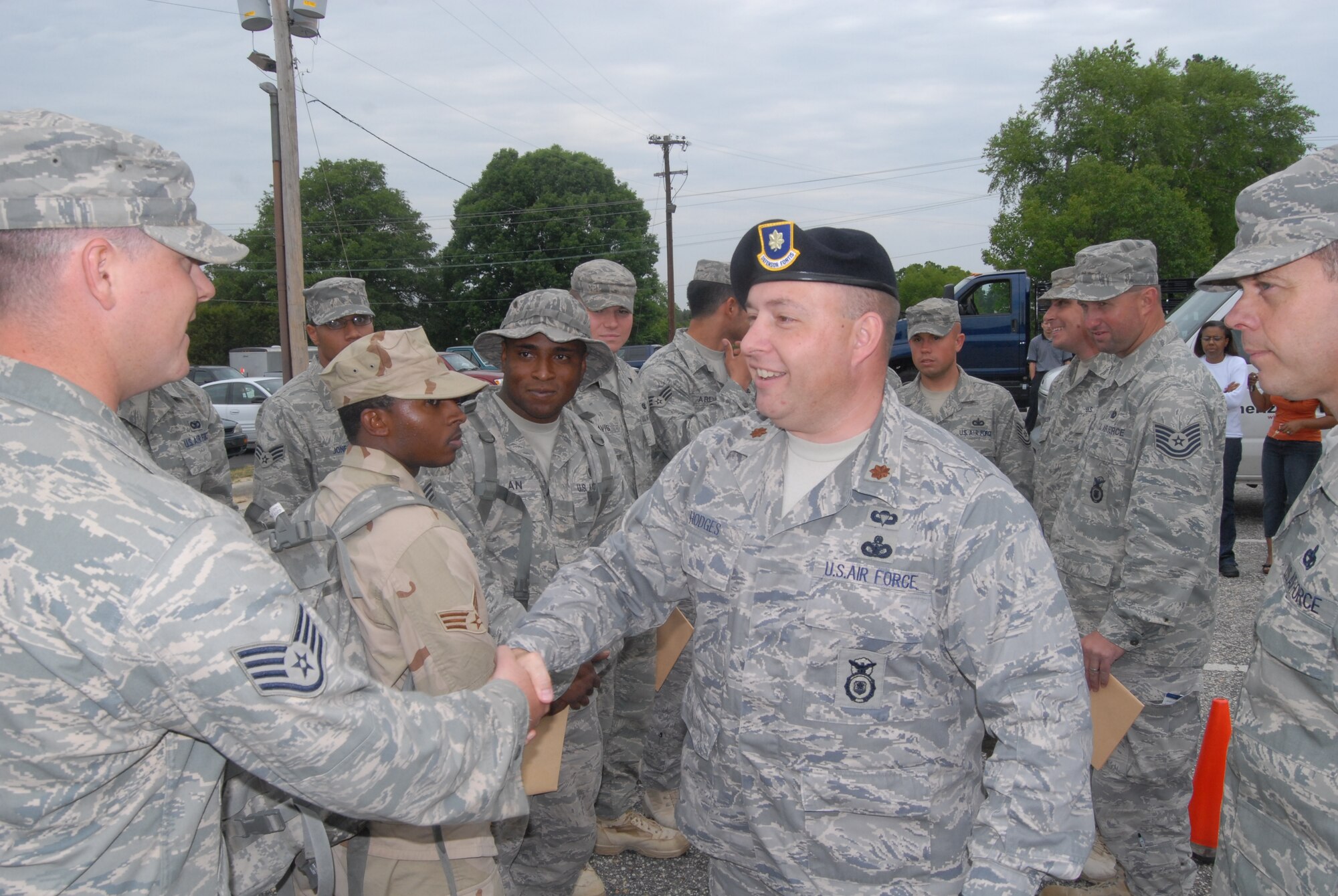 Maj. James Hodges, 43rd Security Forces Squadron Commander, welcomes home Staff Sgt. William Harris, 43rd SFS, and 12 other security forces members from a recent deployment to Camp Bucca, Iraq. (U.S. Air Force Photo by Staff Sgt. Jon LaDue)