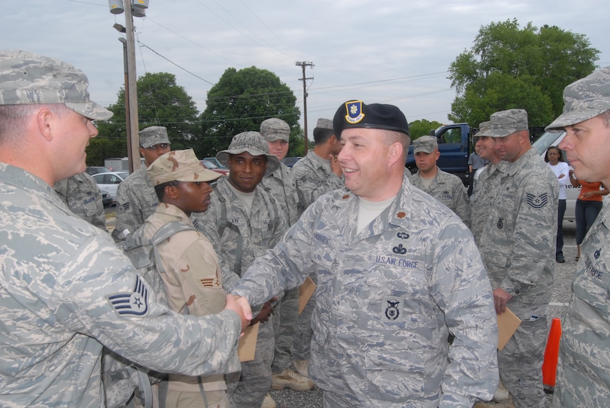 Maj. James Hodges, 43rd Security Forces Squadron Commander, welcomes home Staff Sgt. William Harris, 43rd SFS, and 12 other security forces members from a recent deployment to Camp Bucca, Iraq. (U.S. Air Force Photo by Staff Sgt. Jon LaDue)