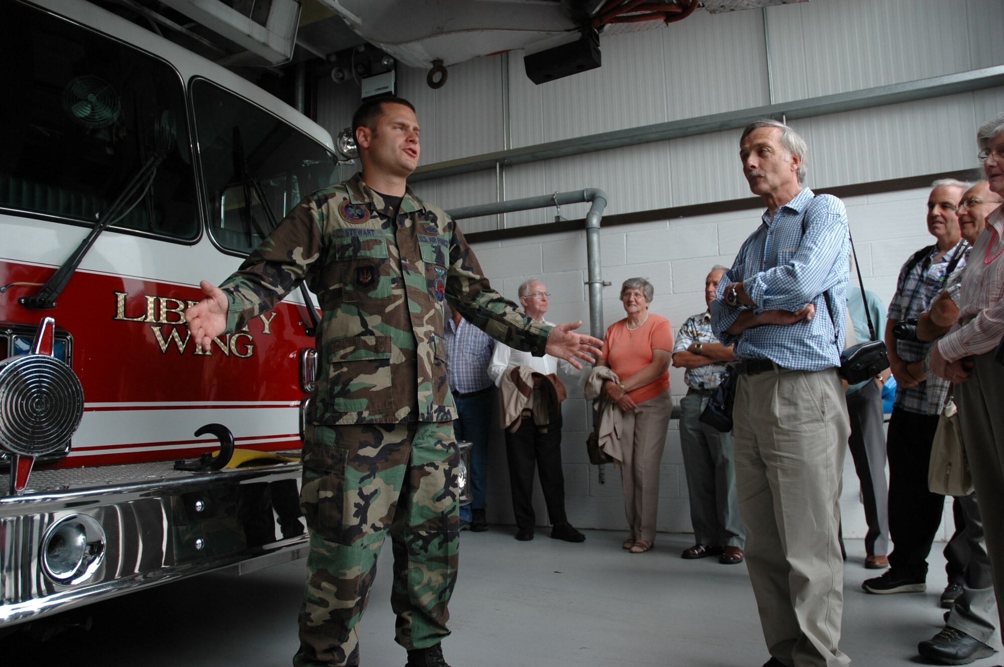 A 48th Civil Engineer Squadron firefighter, talks to a tour coordinated by Doug Wickwar about the capabilities of the fire engines, daily schedules of the firefighters assigned there and daily military life.  Mr. Wickwar has brought nearly 6,000 community members through the base on public affairs community relations tours in the last 20 years. (U.S. Air force photo by Staff Sgt. Nicholasa Reed)