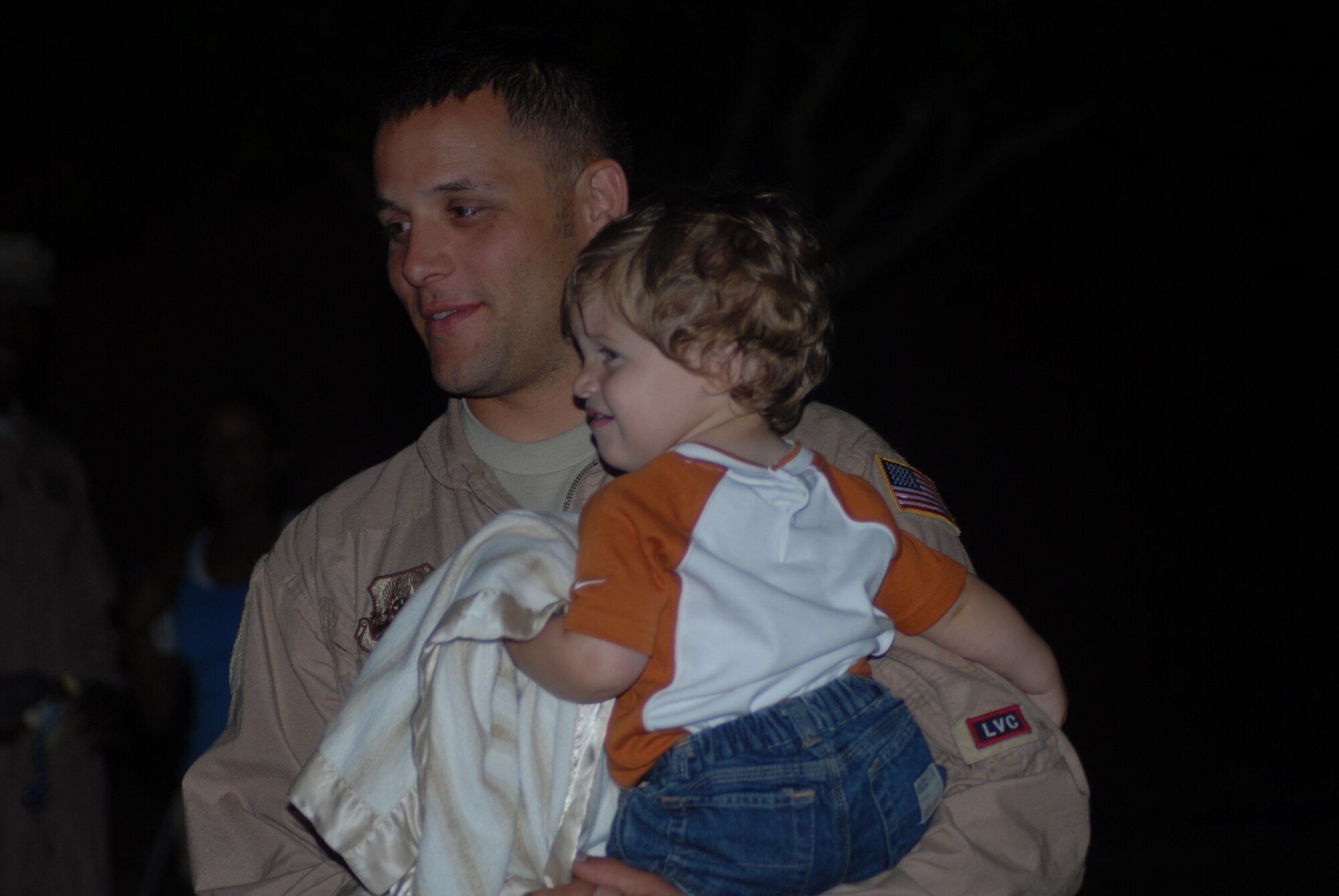 Staff Sgt. Don Downey, 43rd Logistics Readiness Squadron, holds his son, Slade, 1, after returning home from his deployment May 14. (U.S. Air Force Photo by Airman 1st Class Mindy Bloem)