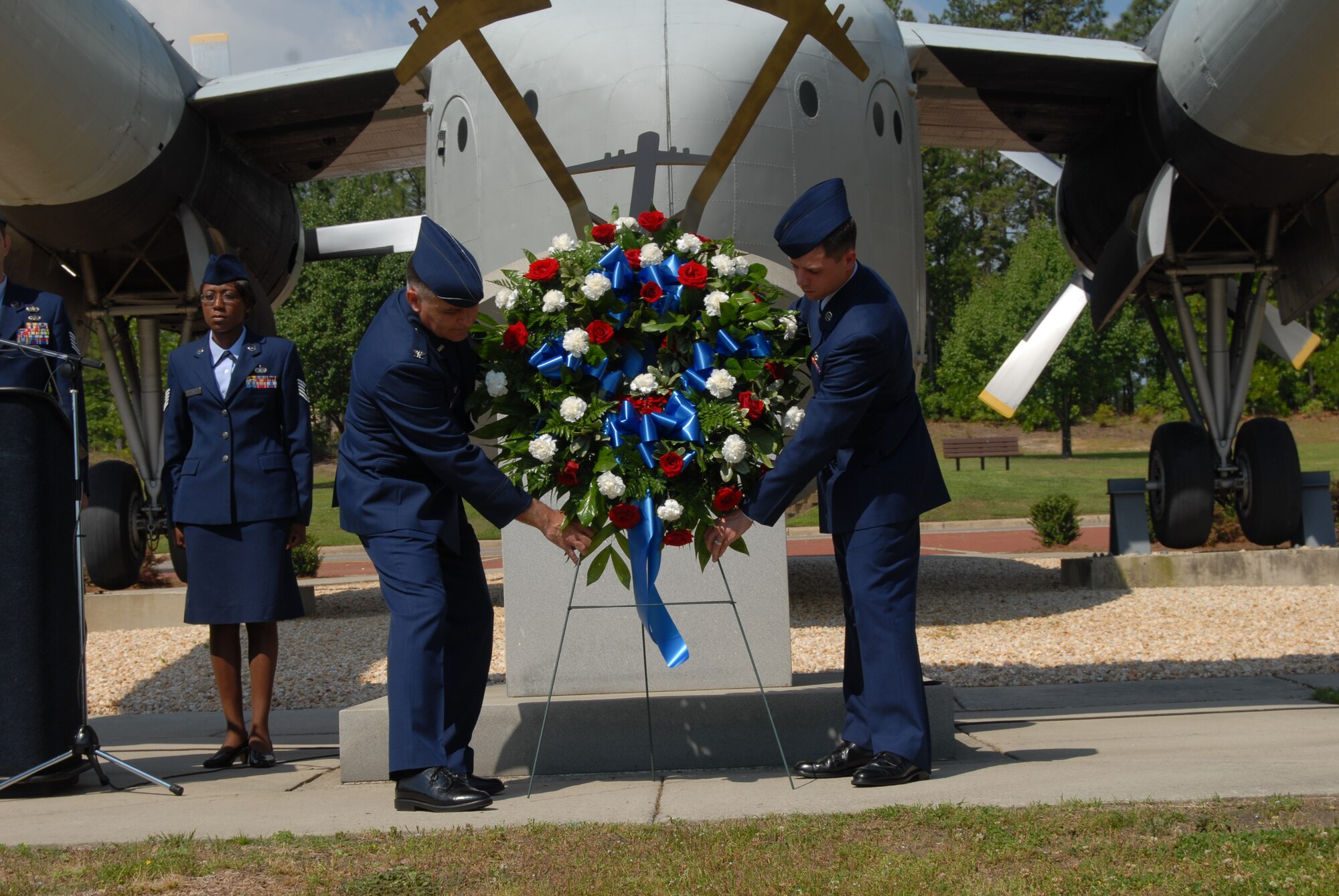 Col. John McDonald, 43rd Airlift Wing Commander, and Airman Basic Samuel Underwood, 43rd Logistics Readiness Squadron, places the wreath on the Air Park Memorial in celebration of Memorial Day as a way to honor the servicemembers who have sacrificed to provide freedom to the United States. It is tradition at Pope for the most senior and junior ranking Airmen to lay the wreath. (U.S. Air Force Photo by Airman 1st Class Mindy Bloem)
