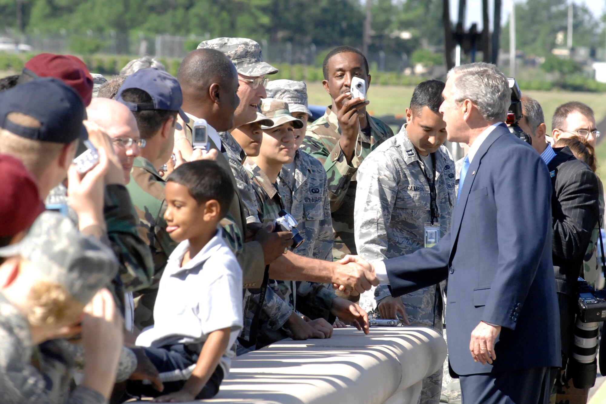 President George W. Bush shakes hands with Chief Master Sgt. Dave Niehaus, 43rd Operations Group, May 22nd on Pope's Green Ramp. President Bush shook hands with more than 30 Pope Airmen after Air Force One landed and departed from Pope for the president's visit to neighboring Fort Bragg for the finale of All-American Week, which included 17,000 Soldiers marching in the 82nd Airborne Division review parade. (U.S. Air Force Photo by Mike Murchison)