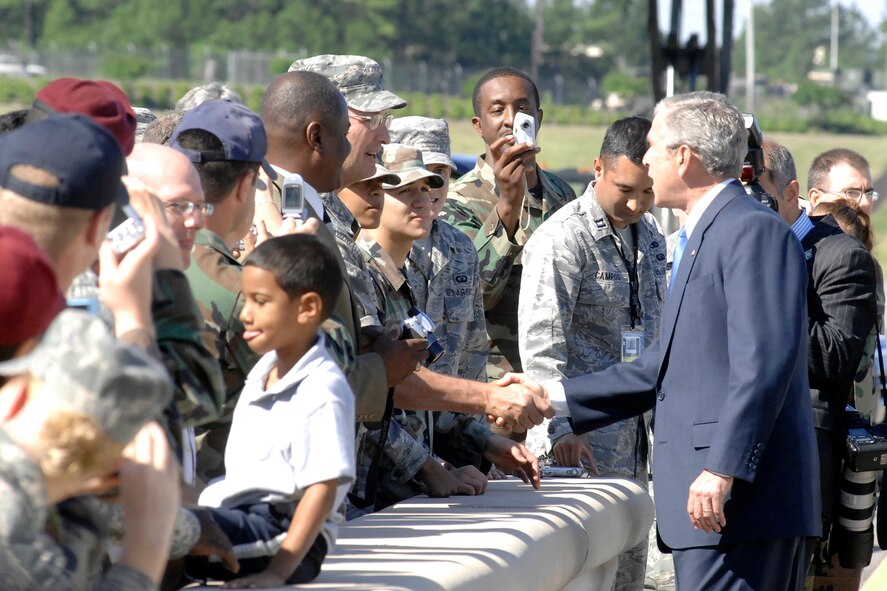 President George W. Bush shakes hands with Chief Master Sgt. Dave Niehaus, 43rd Operations Group, May 22 on Pope Air Force Base's Green Ramp. President Bush shook hands with more than 30 Pope Airmen after Air Force One landed and departed from here for his visit to neighboring Fort Bragg for the finale of All-American Week, which included 17,000 Soldiers marching in the 82nd Airborne Division review parade. (U.S. Air Force Photo by Mike Murchison)