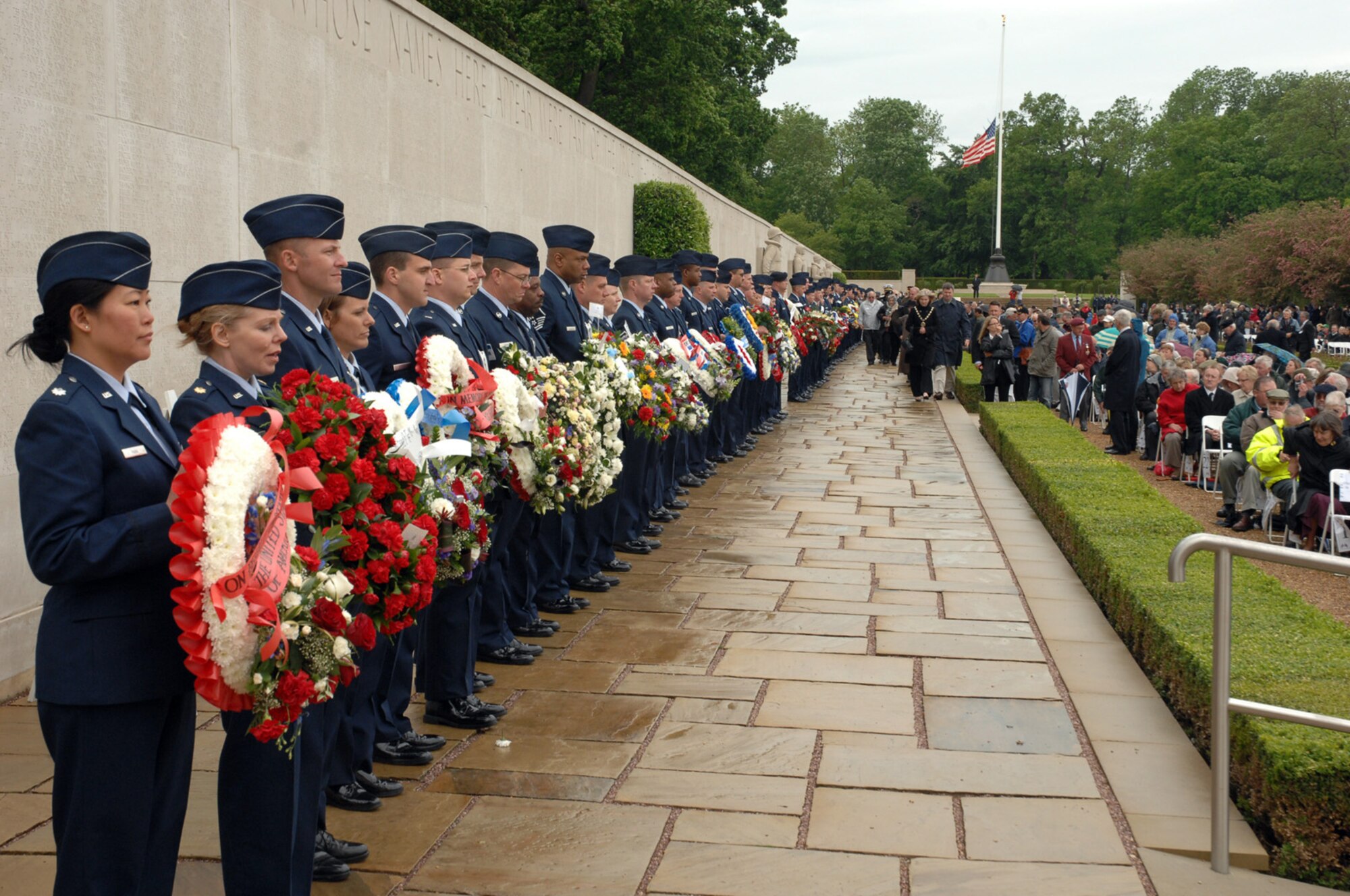 Airmen from RAF Lakenheath and RAF Mildenhall prepare to lay wreaths on the Wall of the Missing at Madingly on Memorial Day May 26 in memory of those who have fallen or are missing from the war. The event honors the memory of American World War II dead who helped achieve victory in Europe against the Axis powers. (U.S. Air Force photo by Airman 1st Class John Easterling)