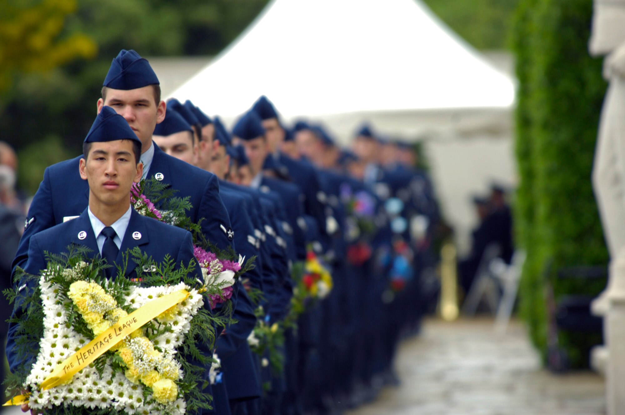 United States Air Force Airmen prepare to present wreaths to verterans and their families May 26. 4,589 of the 8,939 commemorated at the Cambridge (Madingley) American Cemetery are Airmen. Many of those are lost never to have a known resting place, their names inscribed on the Wall of the Missing. (U.S. Air Force photo by Airman Perry Aston)
