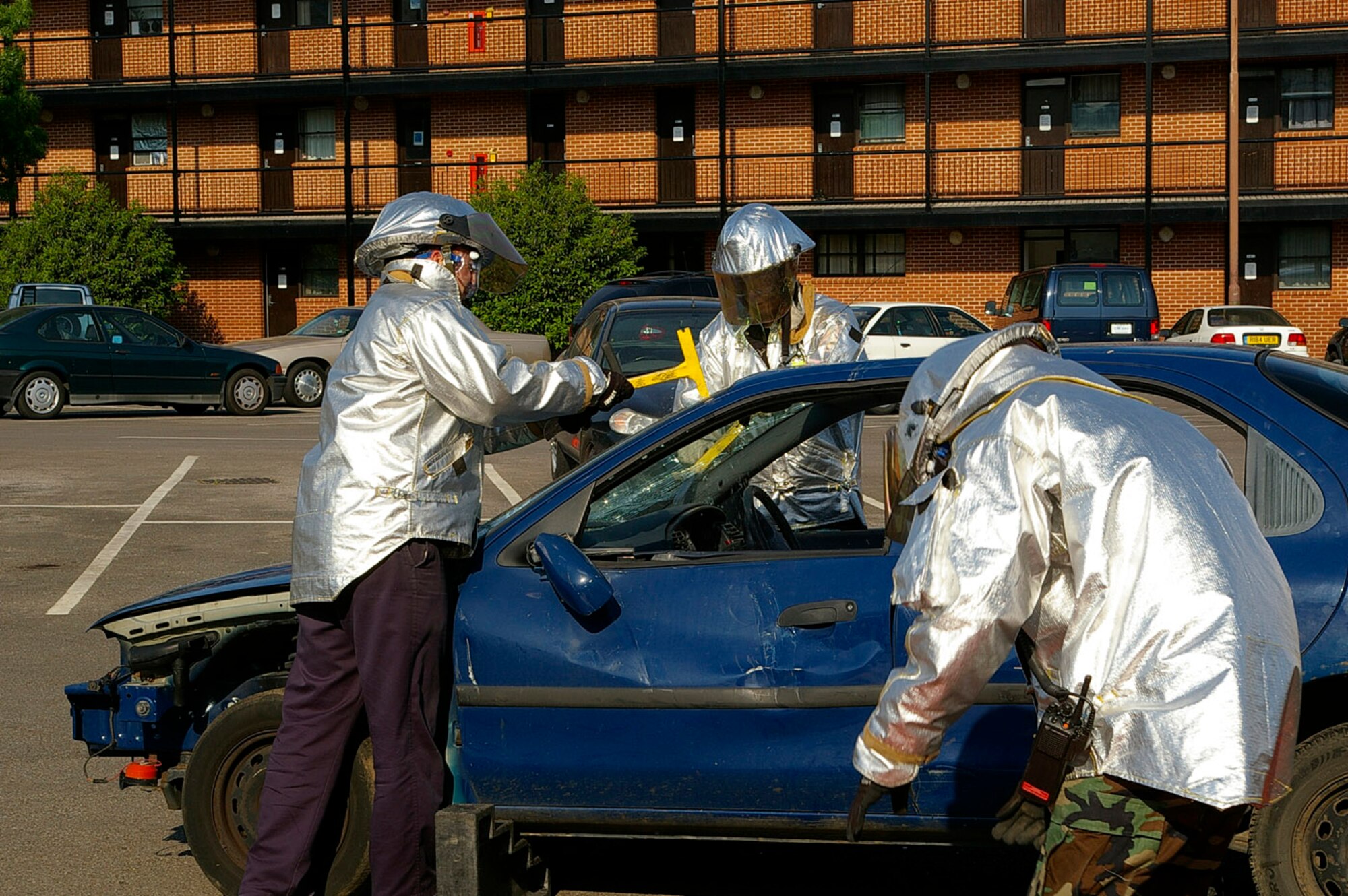 RAF Mildenhall firefighters remove the windscreen from a car during a safety demonstration as part of the USAFE Safety Day May 14. The firefighters showed their audience how they cut up cars when they had to rescue people from accidents. Also as part of the demonstration, people got to try on "drunk goggles" and drive a small motorized vehicle around the parking lot, as well as attempting to walk a straight line and throw a ball. (U.S. Air Force photo by Karen Abeyasekere)