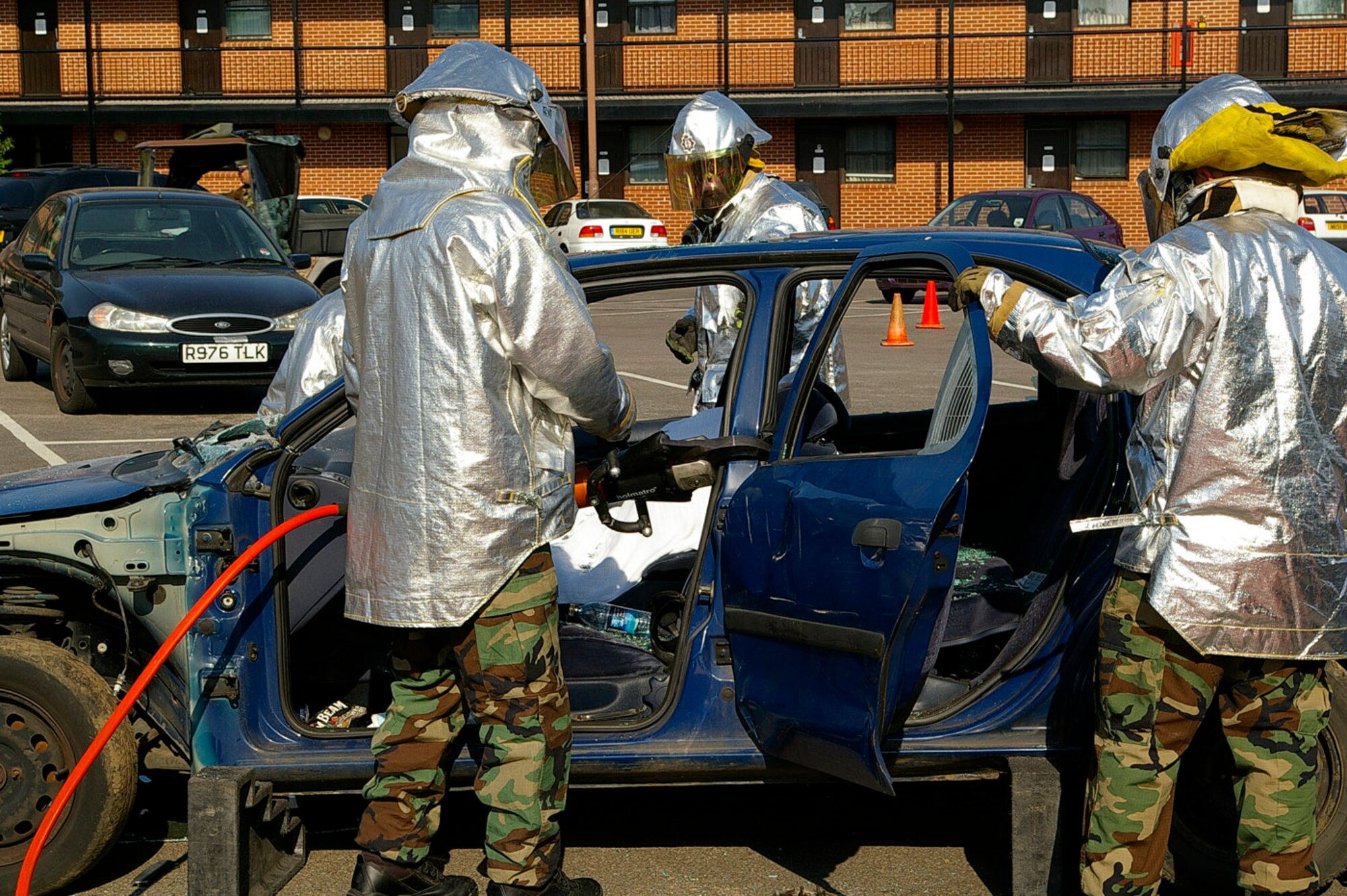 Firefighters from the 100th Civil Engineer Squadron Fire Department use the "jaws of life" to cut off the doors of a car May 14 during a demonstration on U.S. Air Forces in Europe Safety Day at RAF Mildenhall. There were three briefings at the base theater and one at the 100th Operations Group auditorium, and together with presentations, people told their personal stories of how they had been affected somehow through drinking and driving. (U.S. Air Force photo by Karen Abeyasekere)