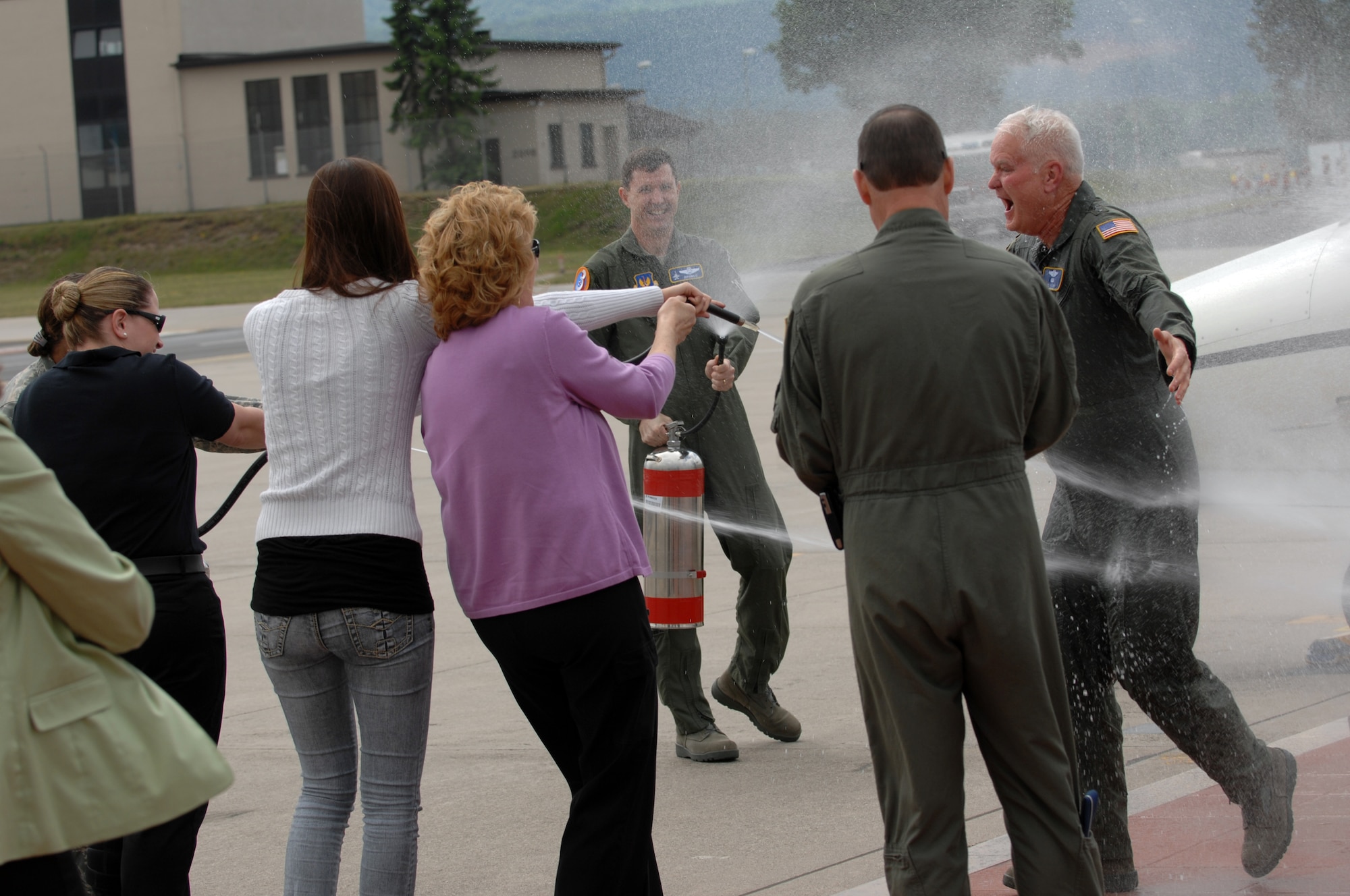 Lt. Gen. Robert D. "Rod" Bishop Jr., 3rd Air Force commander, left, gets sprayed down by family and friends after his final flight, May 23, 2008. For his final flight Lt. Gen. Bishop flew a C-21. (U.S. Air Force photo by U.S. Airman 1st Class Nathan Lipscomb) (RELEASED*)