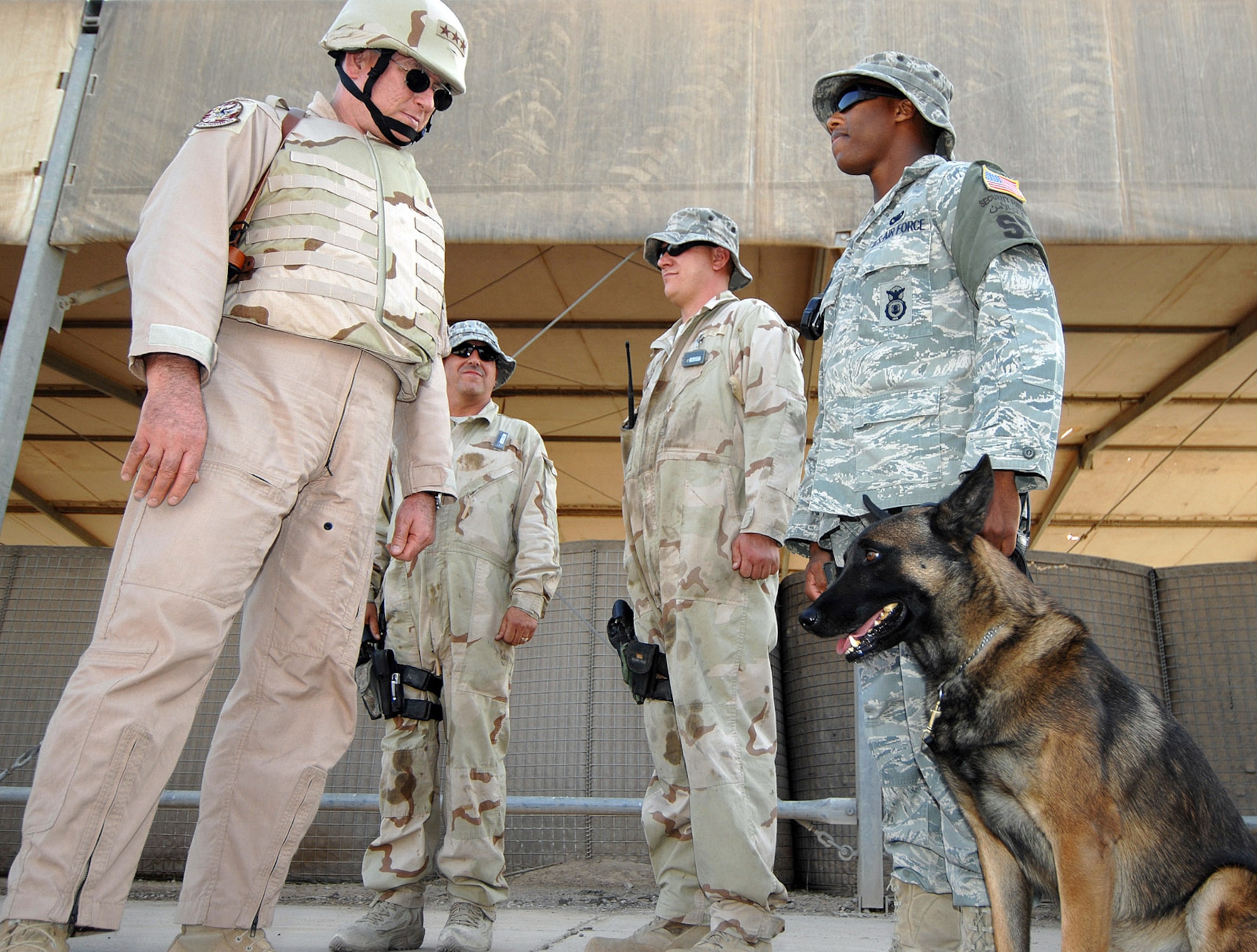 Lt . Gen. John Bradley, commander of Air Force Reserve Command (left), greets K-9 handler Senior Airman Mark Bush and a military working dog during his visit May 25 here. General Bradley is visiting Airmen throughout the deployed environment to thank them for their service supporting the Global War on Terrorism. U.S. Air Force photo by MSgt Rick Sforza (RELEASED)