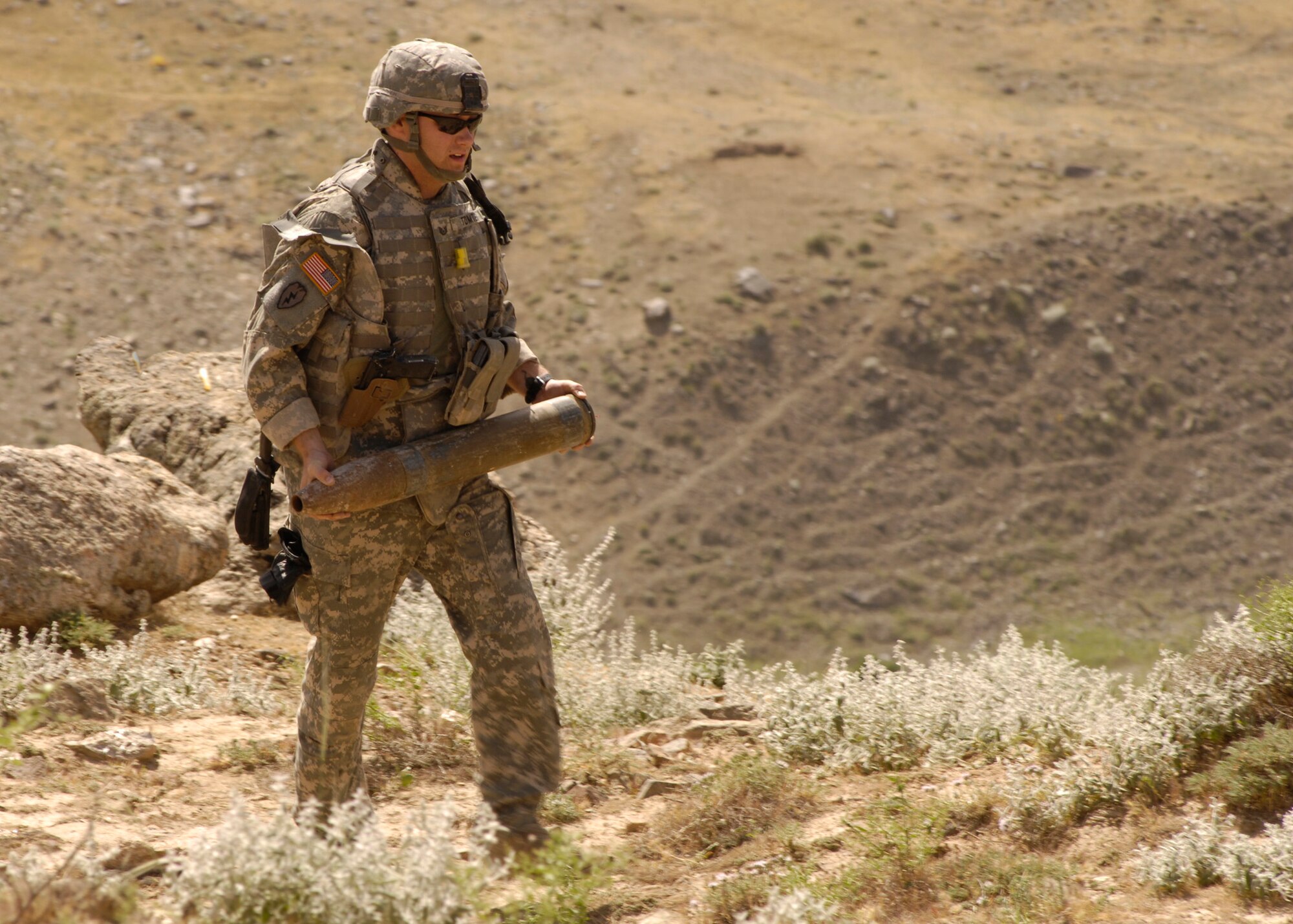 PANJSHIR PROVINCE, Afghanistan – Tech. Sgt. Jay Tomten, 755th Air Expeditionary Group Explosive Ordnance Disposal team leader, transports a rocket to a safe disposal area for detonation after a local farmer alerted authorities when he found two 107 mm rockets.  Sergeant Tomten is deployed from the 49th Civil Engineer Squadron EOD Flight, Holloman Air Force Base, N.M.  (U.S. Air Force Photo by Master Sgt. Demetrius Lester)