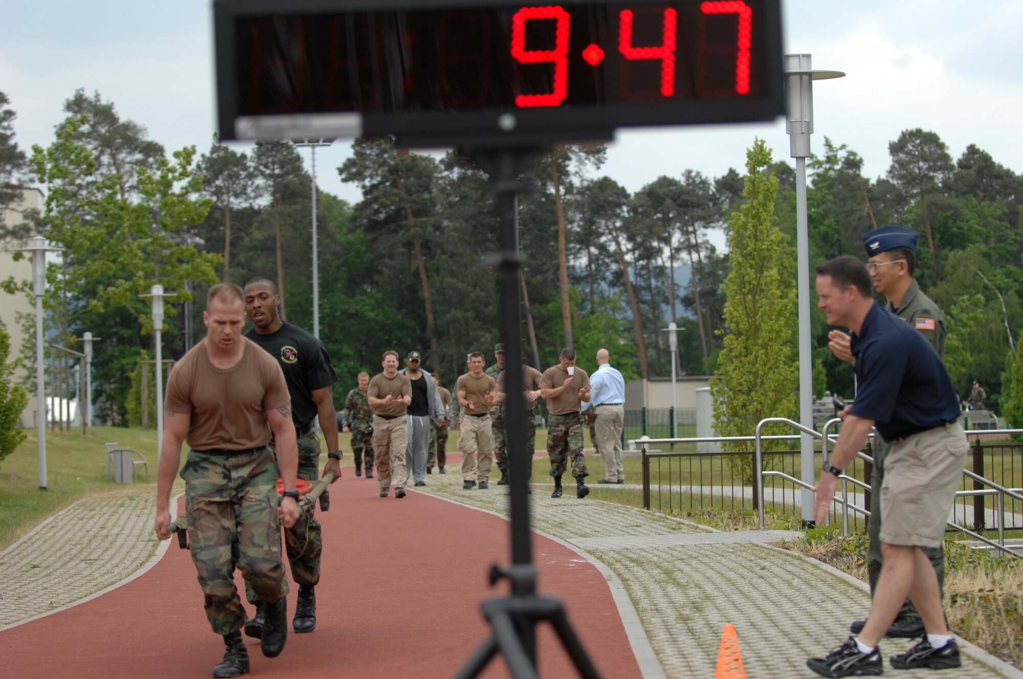 Staff Sgt. Christopher Clawson and Staff Sgt. Dwight Scott bring in the winning time of 9:49 while carrying 190 lbs. on a gurney as part of the Total Fit challenge hosted by the Health and Wellness Center, Ramstein Air Base, Germany, May 21, 2008. Participants went through a gauntlet of exercises designed to simulate situations Airmen may go through on deployments. (U.S. Air Force photo by U.S. Airman 1st Class Nathan Lipscomb) (RELEASED*)