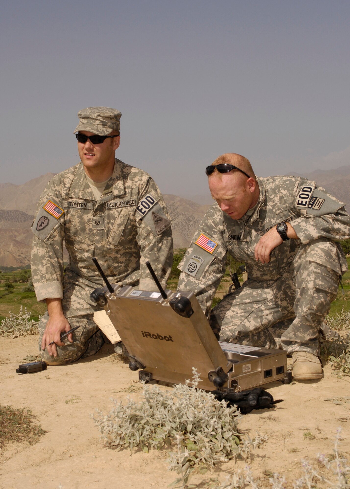 PANJSHIR PROVINCE, Afghanistan - Tech. Sgt. Jay Tomten (left) 755th Air Expeditionary Group, Explosive Ordnance Disposal team leader, and Staff Sgt. Jason Snow, 755 AEG robot operator, prepare to send a PACBOT to an incident site where two 107 mm rockets on a timer were aimed at a coalition forward operating base.  Sergeant Tomten is deployed from the 49th Civil Engineer Squadron EOD Flight, Holloman Air Force Base, N.M. Sergeant Snow is deployed from 1 CES EOD Flight, Langley Air Force Base. Va. (U.S. Air Force Photo by Master Sgt. Demetrius Lester)