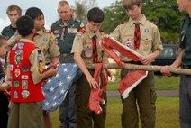 Members of the Scout Pack and Troop 20 burn the retired flag at the Arc Light Memorial Park on Andersen AFB, May 22, 2003. This troop is one of few Boy Scout troops that retire the American Flag in this manner. (U.S. Air Force photo by Airman First Class Courtney Witt)