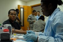 U.S. Army Specialist Thomas takes vital signs of blood donor at the annual Blood Drive on Andersen Air Force Base, Guam on May 20, 2008. Specialist Thomas is a lab technician for this year’s Armed Service Blood Bank team. (U.S. Air Force photo by Airman First Class Courtney Witt)