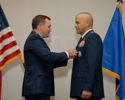 Brig. Gen. Douglas Owens 36th Air Base Wing Commander presents Lt. Col. Peter Ridilla Commander of the 36th Civil Engineer Squadron the Bronze Star on May 22 here. The Bronze Star is awarded to Airmen who have distinguished themselves by heroic or meritorious achievement or service not involving participation in aerial flight, in connection with military operations against an armed enemy. (U.S. Air Force photo/ A1C Courtney Witt)
