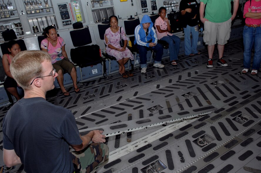 Tech. Sgt. Christopher Fietzer of the 734th Air Mobility Squadron explains the Ariel Pollers Delivery System to members of the Big Brothers Big Sisters Program of Guam on May 24 here.  The Big Brothers Big Sister program of Guam toured HSC-25, the 734th Air Mobility Squadron, a U.S. Air Force C-17 Globemaster and C-5 Galaxy. (U.S. Air Force photo by Airman 1st Class Nichelle Griffiths)  