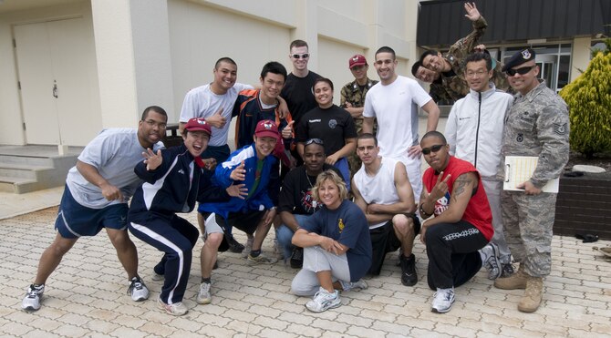 MISAWA AIR BASE, Japan -- The participants of the 2008 Police Week Physical Fitness challenge pause for a group photo outside the base gym on May 16, 2008. The competing teams from the 35th Security Forces Squadron, Naval Air Facility Security Detatchment and the Japan Air Self-Defense Force insisted on mixing up the members for the photo to demonstrate and foster the cooperative nature of the joint-force facility. (U.S. Air Force photo by Senior Airman Samuel Morse)