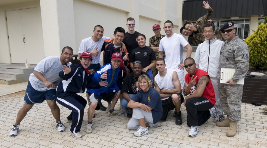 MISAWA AIR BASE, Japan -- The participants of the 2008 Police Week Physical Fitness challenge pause for a group photo outside the base gym on May 16, 2008. The competing teams from the 35th Security Forces Squadron, Naval Air Facility Security Detatchment and the Japan Air Self-Defense Force insisted on mixing up the members for the photo to demonstrate and foster the cooperative nature of the joint-force facility. (U.S. Air Force photo by Senior Airman Samuel Morse)