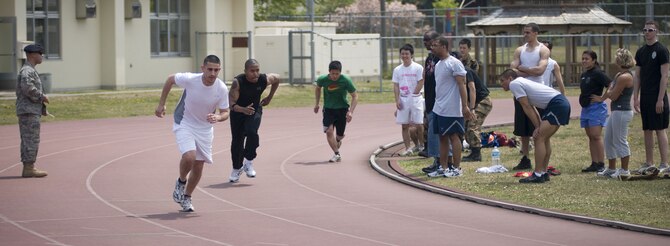 MISAWA AIR BASE, Japan -- Representatives from the Naval Air Facility Security Detachment, 35th Security Forces Squadron and Japan Air Self-Defense Force begin a two-mile relay race at the Edgren High School track on May 16, 2008. The race was part of the a physical fitness challenge between the three services, finishing out "Police Week" at Misawa Air Base. (U.S. Air Force photo by Senior Airman Samuel Morse)