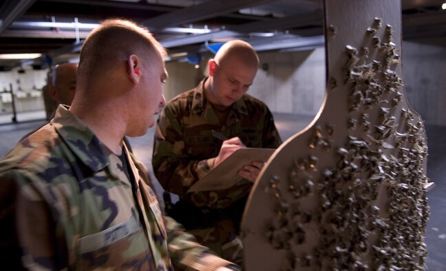 MISAWA AIR BASE, Japan -- Tech. Sgt. Jeremy Potts, 35th Security Forces Squadron, gives Petty Officer 2nd Class Adam St. Clair, Naval Air Facility Security Detatchment, his score at the combat arms firing range on May 14, 2008. Petty Officer St. Clair participated in a joint-force M9 firing competition during "Police Week". (U.S. Air Force photo by Senior Airman Samuel Morse)