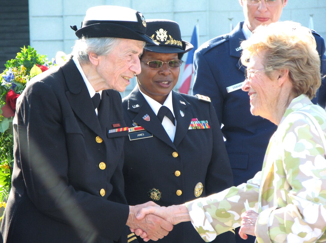 Retired Navy Master Chief Petty Officer Anna Der-Vartanian, left, shakes hands with retired Air Force Maj. Gen. Jeanne Holm during a Memorial Day ceremony held at the Women in Military Service for America Memorial, Arlington National Cemetery, Arlington, Va., May 26, 2008.