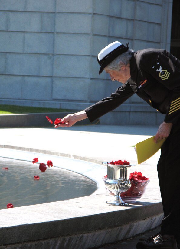 Retired Navy Master Chief Petty Officer Anna Der-Vartanian places some rose petals into the reflecting pool at the Women in Military Service for America Memorial’s annual Memorial Day observance, Arlington National Cemetery, Arlington, Va., May 26, 2008. Der-Vartanian, who joined the Navy in 1943, became the Navy’s first woman master chief petty officer, the highest enlisted grade. 