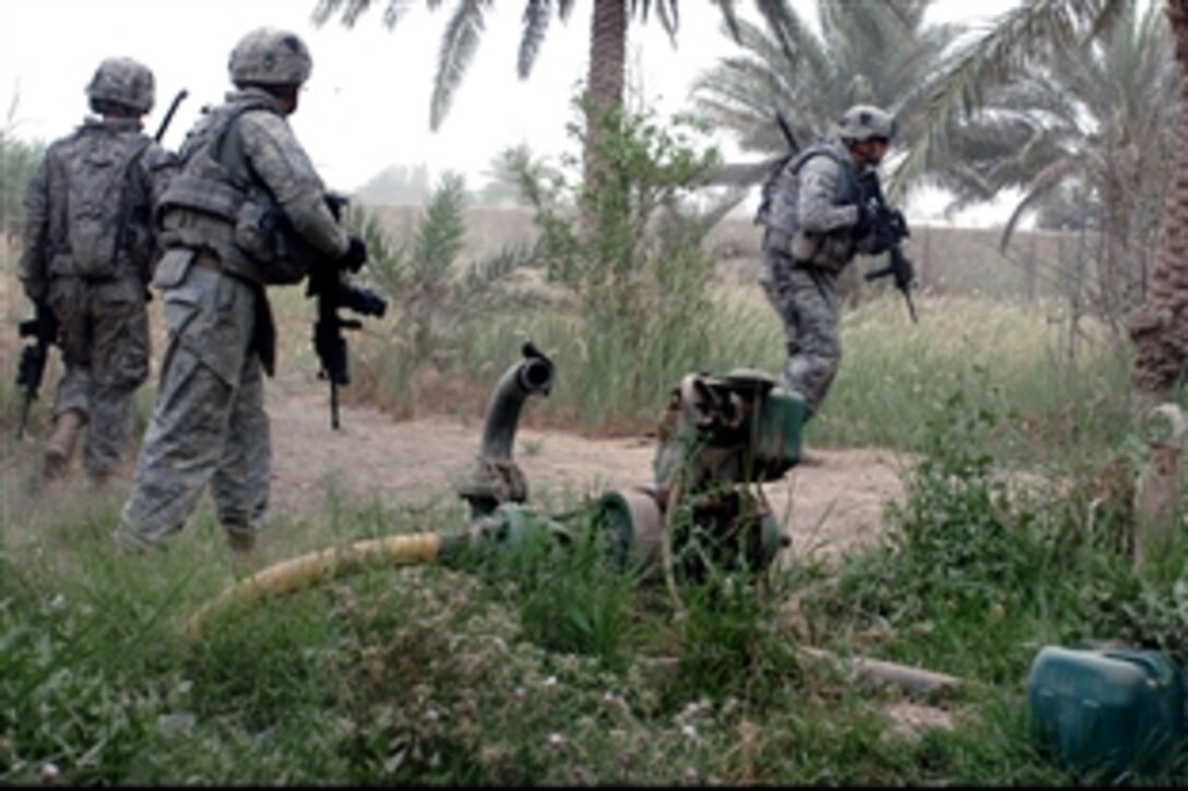 U.S. Army soldiers maneuver down a path while receiving heavy indirect fire and rocket-propelled grenade fire just on the outskirts of Shulla, Iraq,  May 16, 2008. The soldiers assigned to the 101st Airborne Division's 1st Squadron, 75th Cavalry Regiment, 2nd Brigade Combat Team, were in the area searching for a possible weapons cache when an improvised-explosive device was detonated. 
