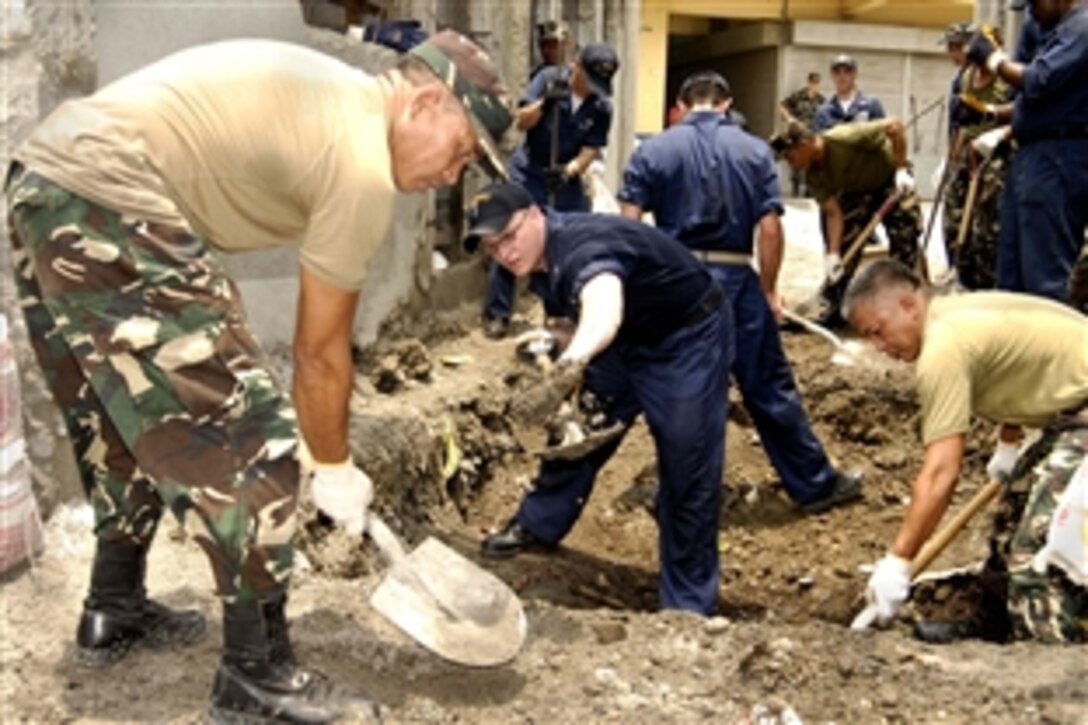 U.S. sailors and Philippine soldiers dig a foundation for a home during a joint military community relations project with the Gawad Kalinga Community Development Foundation in Manila, Philippines, May 23, 2008. The sailors are assigned to the USS Blue Ridge, the flagship for Commander, U.S. 7th Fleet. 