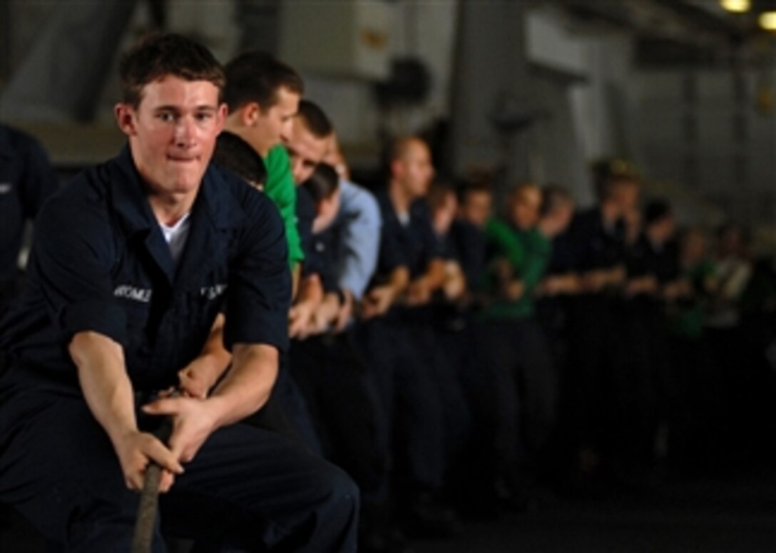 U.S. Navy Seaman Buck Bromley and other sailors heave a messenger line aboard the Nimitz-class aircraft carrier USS Abraham Lincoln (CVN 72) during an underway replenishment with the fast combat support ship USNS Rainer (T-AOE 7) while in the Persian Gulf on May 22, 2008.  The Lincoln is deployed to the 5th Fleet area of responsibility to support maritime security operations.  