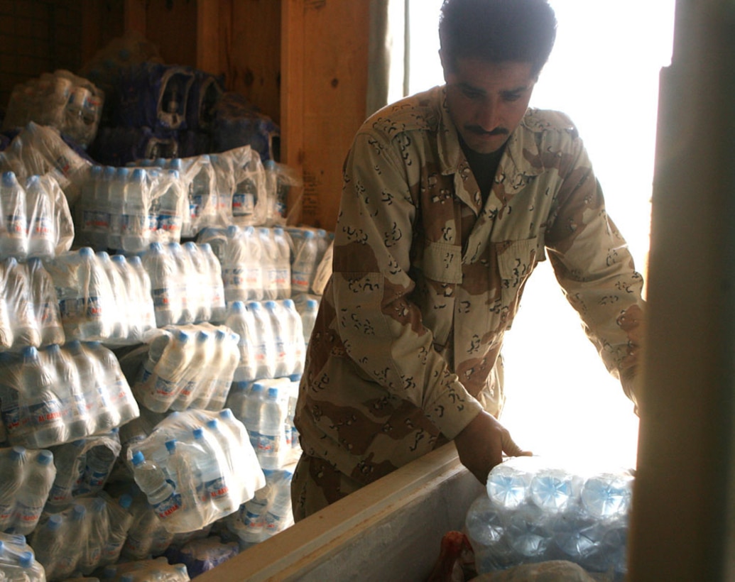 Saad El-Ghalby, an Iraqi soldier, re-supplies a water cooler at Combat Outpost Timberwolf, Iraq, May 27. Marines with Headquarters Company, Regimental Combat Team 5 relieved Marines with 3rd Battalion, 4th Marine Regiment, RCT-5 earlier this year. The trend has continued as the Marines trained Iraqi Army soldiers with the 7th Iraqi Army Division, 22nd Army Brigade to take full control of the outpost and surrounding area. The Marines trained the soldiers on patrolling procedures, guard duty and security measures.