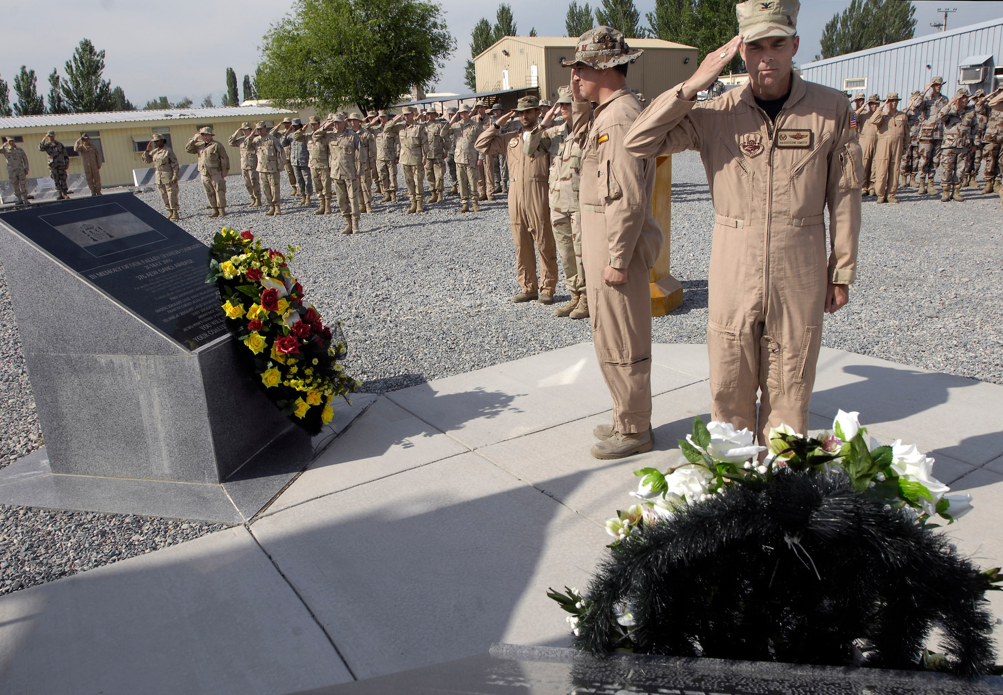 Col. Harrison Smith and Maj. Santiago Ibarreta lead the men and women of the 376th AEW and coalition team in remembering the fallen during a May 26 Memorial Day ceremony. The Manas AB coalition also paused to honor the fallen Spanish airmen and soldiers which marked the five year anniversary of 62 Spanish servicemembers lost in a 2003 commercial contract plane crash in Turkey. Colonel Smith is the 376th Air Expeditionary Wing commander and Major Ibarreta is the Spanish Air Force Mizar detachment commander at Manas Air Base, Kyrgyz Republic. (U.S. Air Force photo/Staff Sgt. Tabitha Kuykendall) 