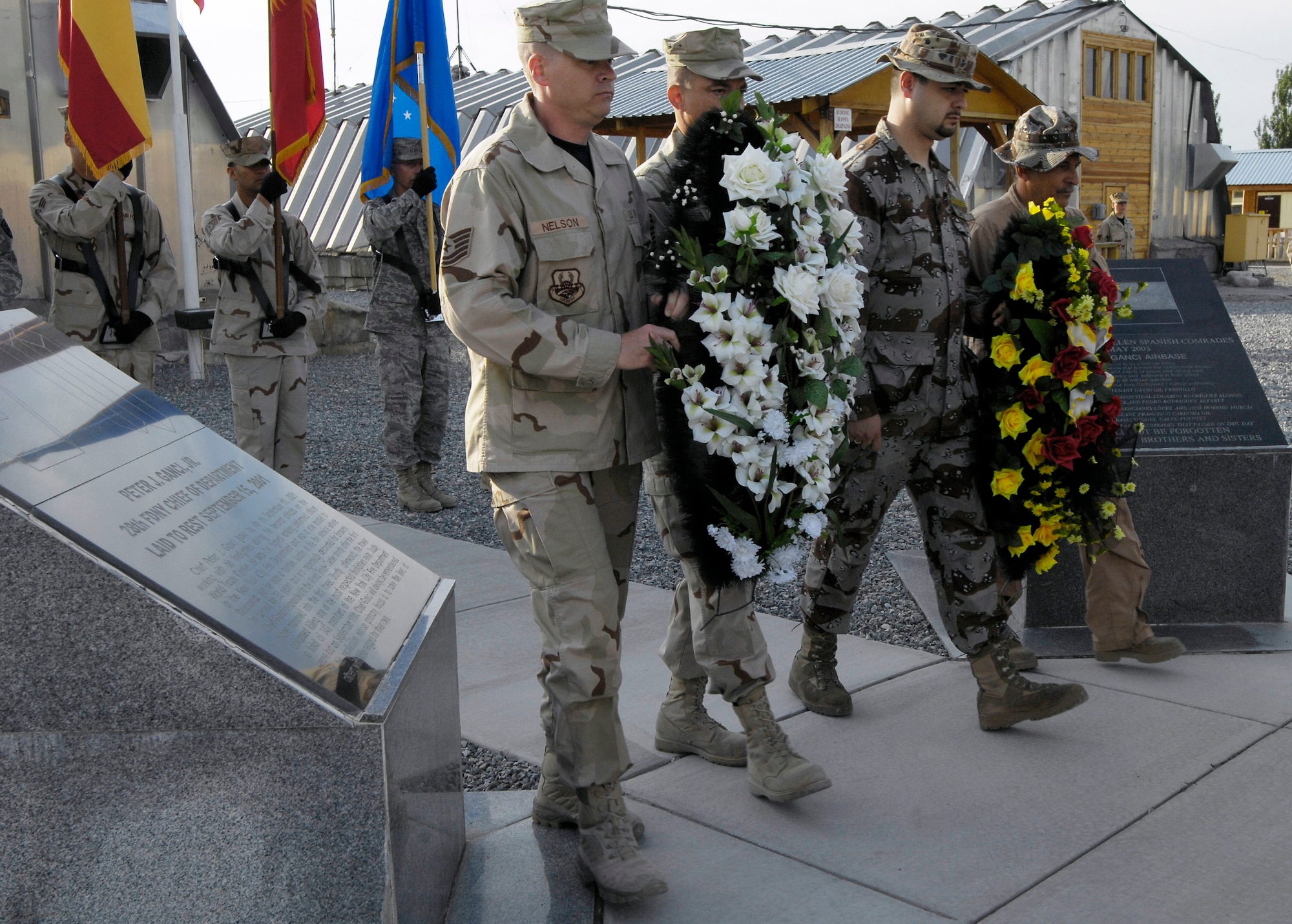 Men and women of the 376th Air Expeditionary Wing, Manas Air Base, Kyrgyz Republic, and coalition team gathered to remember the fallen in a May 26 Memorial Day ceremony. The Manas AB coalition also paused to honor the fallen Spanish airmen and soldiers which marked the five year anniversary of 62 Spanish servicemembers lost in a 2003 commercial contract plane crash in Turkey. (U.S. Air Force photo/Staff Sgt. Tabitha Kuykendall) 
