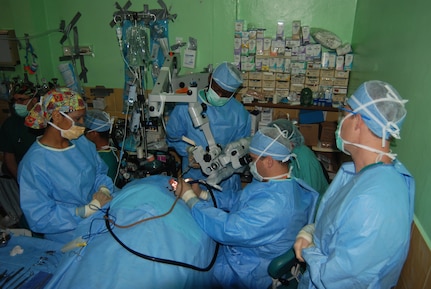 A surgical team from Walter Reed Army Medical Center perfom ear surgery on a Honduran patient at Hospital Leonardo Martinez V. in San Pedro Sula, Honduras. The team was part of a readiness training mission in Honduras May 17-28 and performed surgeries on 55 local Hondurans. (U.S. Air Force photo/Tech. Sgt. John Asselin)