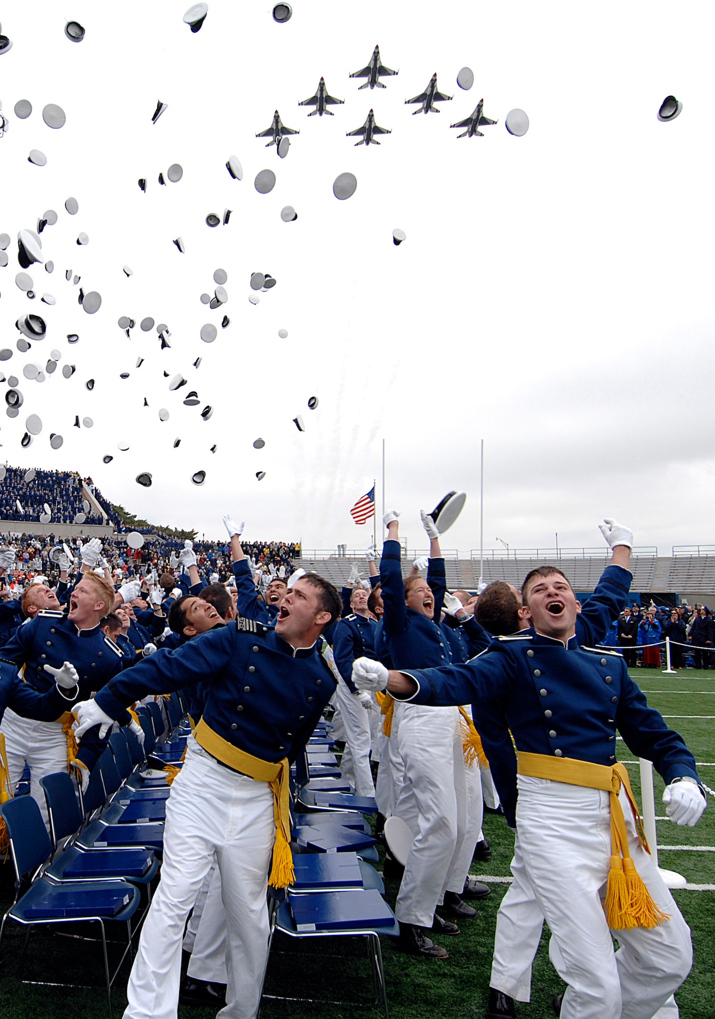 The Air Force Thunderbirds fly over the U.S. Air Force Academy's Falcon Stadium as 1012 newly graduated second lieutenants, members of the Class of 2008, toss their hats in the air at the conclusion of graduation ceremonies. President George W. Bush was the commencement speaker.  (U.S. Air Force photo/Dave Ahlschwede)