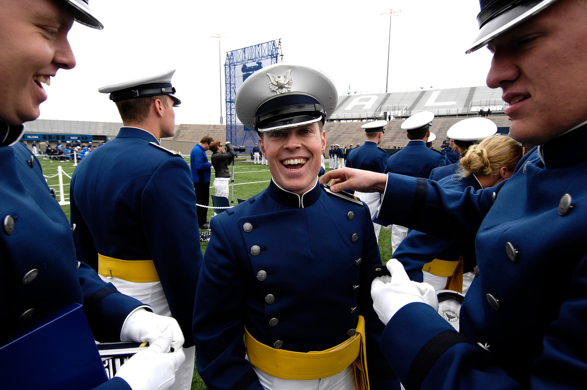 Newly-graduated 2nd Lt. Andrew Derwae has his shoulder boards fastened by members of his squadron during the U.S. Air Force Academy Class of 2008 Graduation Ceremony at Falcon Stadium May 28.  The Class of 2008, the 50th Academy class, comprised 1,012 cadets who will enter the Air Force as second lieutenants.  (U.S. Air Force photo/Mike Kaplan)