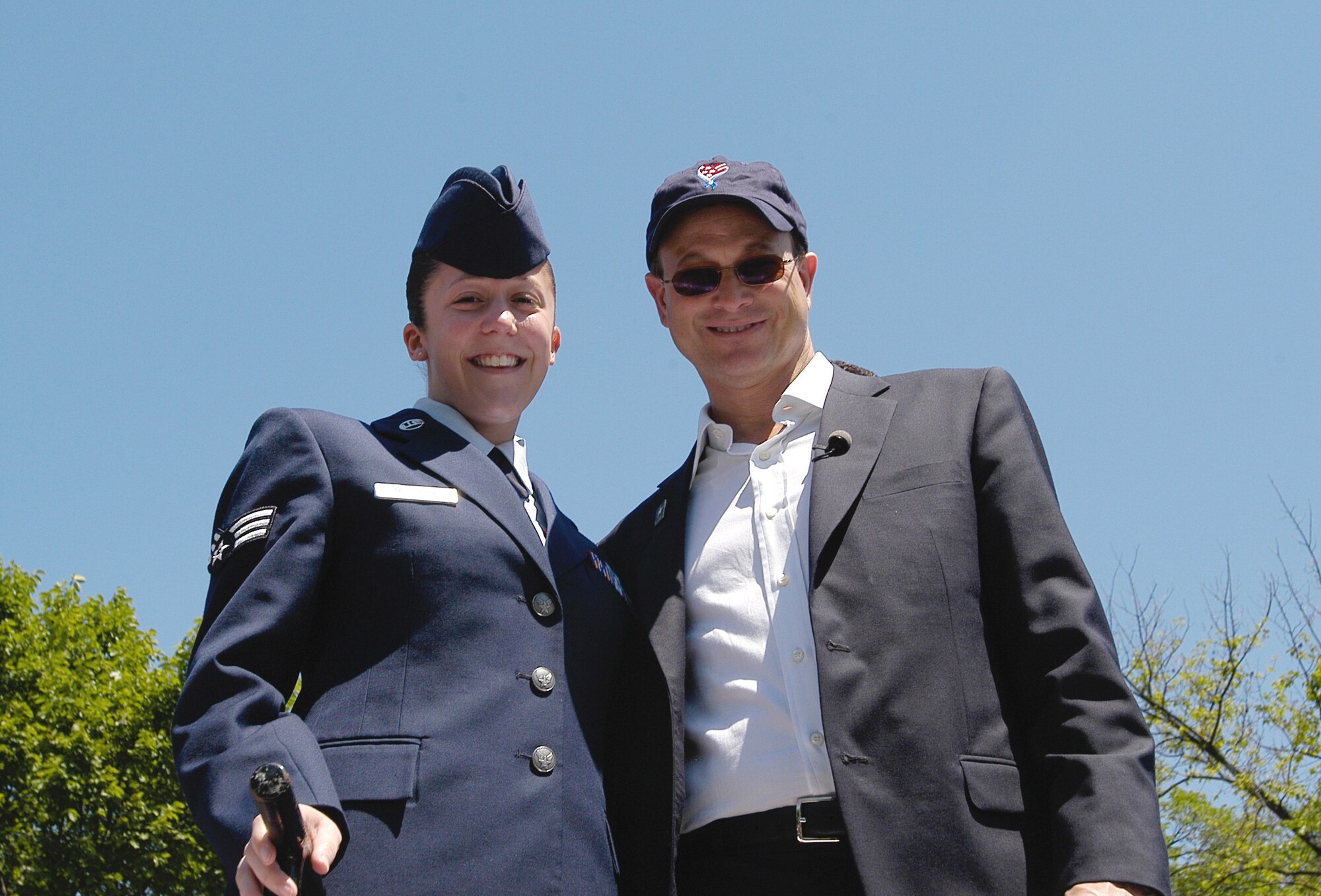 Senior Airman Mary Bullock, 11th Intelligence Squadron, poses with actor Gary Sinise at the National Memorial Day Parade. Mr. Sinise, a military advocate, is the star of CSI: New York and best known in military circles for his role as Lt. Dan in Forrest Gump. His band, the Lt. Dan Band, plays for American servicemembers around the world. (U.S. Air Force photo/Tech. Sgt. John Jung)                             