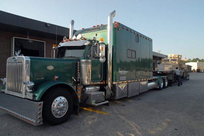 A trailer loaded with a mine-resistant, ambush-protected vehicle is hitched to a truck in the 437th Aerial Port Squadron yard. The 437 APS traffic management office has been coordinating shipment of MRAPs to Marine Corps camps throughout the United States and overseas to be used for training purposes. (U.S. Air Force photo/Senior Airman Sam Hymas)
