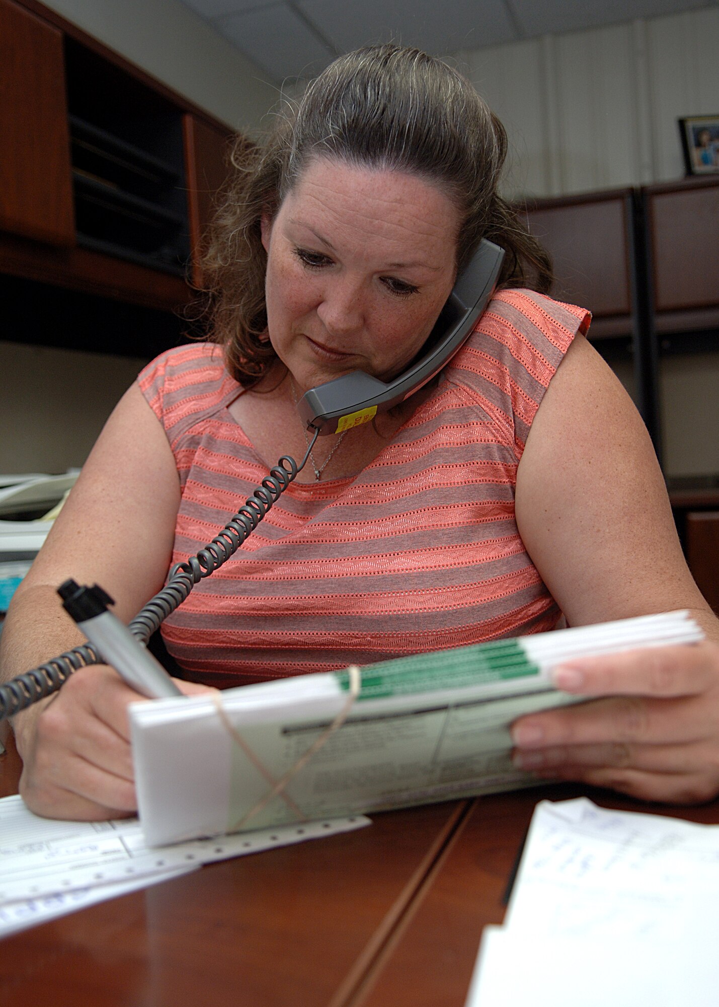 Ms. Jeannette Burns, Base Information Transfer flight manager, from the 49th Communications Squadron calls to double check the address of a squadron May 27, on Holloman Air Force Base, N.M.  The mail room also receives sorts and distributes squadron and flight mail. (U.S. Air Force photo/Airman 1st Class John Strong) 