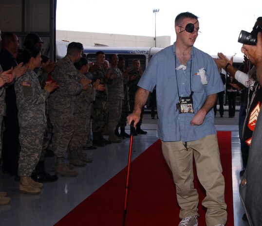 Air Force, Army, Navy and Marine active-duty, reserve and civilian personnel, and retirees from Nellis Air Force Base and the Las Vegas valley came together to thank their brothers in arms for their service during a ceremony at the Executive Airport on May 22. Close to 40 wounded troops and their families traveled from Bethesda Naval Hospital and Walter Reed Army Medical Center to enjoy an all-expense paid vacation, sponsored by the Venetian Hotel-Resort-Casino. The ceremony entailed the U.S. Marine Corps color guard posting the colors, Master Sgt. Robert Brooks, Nellis Air Force Base’s Airman Leadership School flight chief, singing the national anthem, and Sheldon Adelson, Chairman and Chief Executive Officer of the Las Vegas Sands Corp., as the guest speaker. (U.S. Air Force photo by Capt. Jessica Martin)