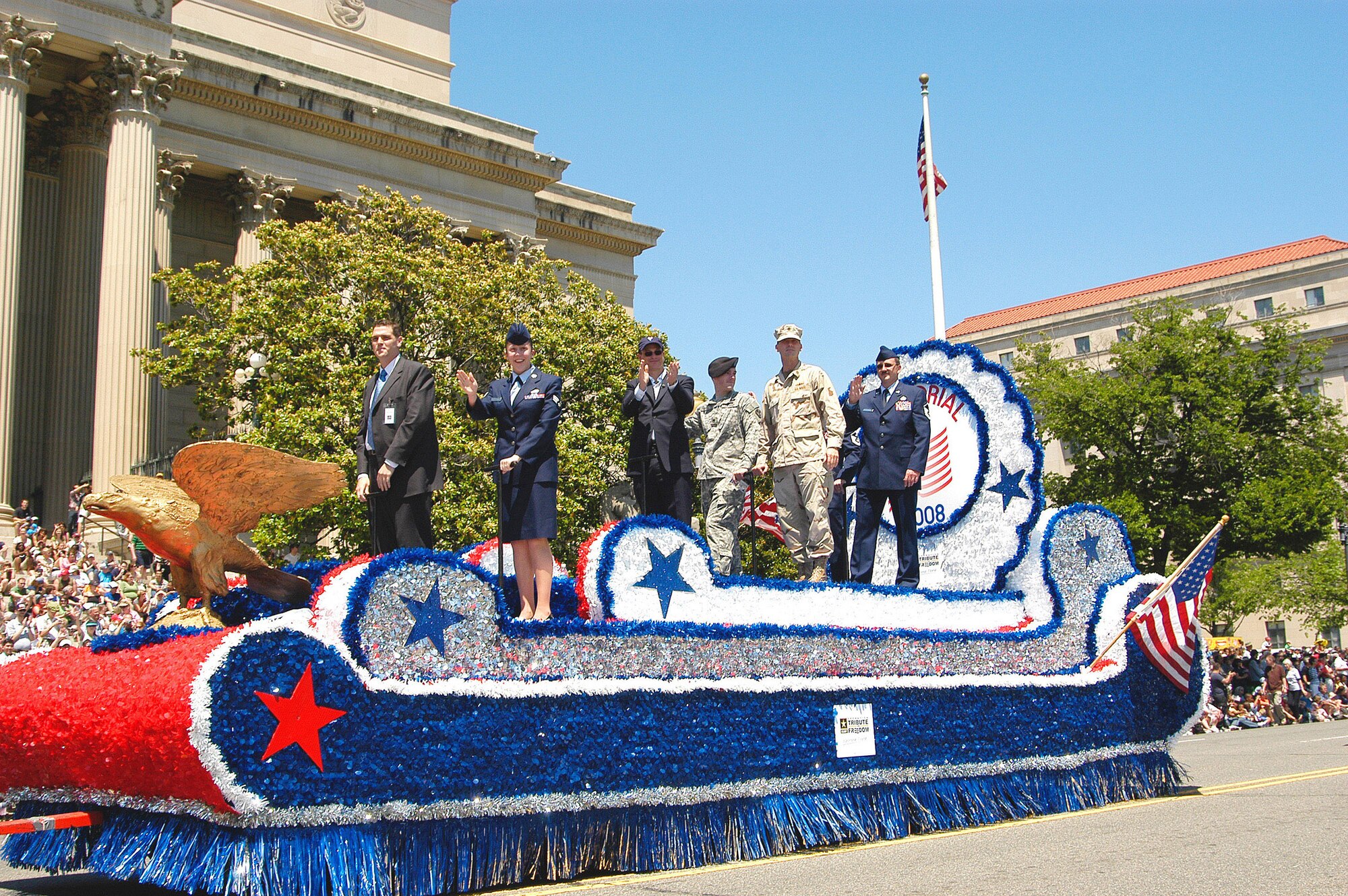 Special Agent Jac Christiansen (far right), Air Force Office of Special Investigations, Detachment 406, Columbus Air Force Base, Miss., and Senior Airman Mary Bullock (second from left), 11th Intelligence Squadron, Hurlburt Field, Fla., were handpicked by Air Force leadership to be grand marshals in this year's parade because of their heroic acts or outstanding work in support of Operations Iraqi Freedom or Enduring Freedom. Also aboard the lead float was actor and Grand Marshal Gary Sinise. (U.S. Air Force photo/Tech. Sgt. John Jung) 