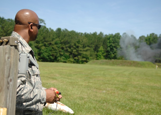 Staff Sgt. Carl Makins Jr. initiates explosives with an electric firing device at a secure location on Charleston AFB May 22. The explosive ordnance disposal team routinely detonates explosives as part of demolition qualifaction training. Sergeant Makins is an EOD technician reservist with the 437th Civil Engineer Squadron.  (U.S. Air Force photo/Airman 1st Class Katie Gieratz)
