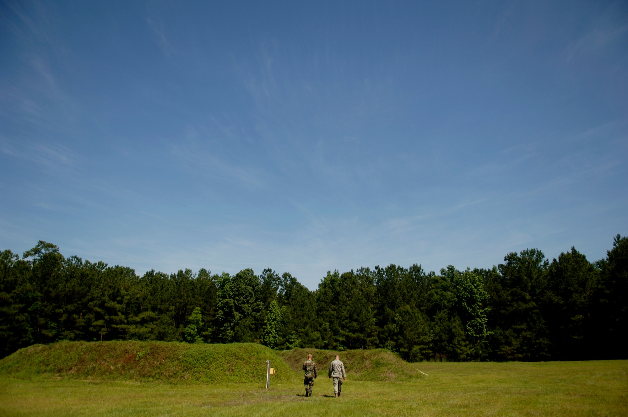 Senior Airmen Ryan McCary and Johnathan Baxley survey the area after detonating TNT at a secure location on Charleston AFB May 22. Airman Baxley is an EOD equipment supervisor and Airman McCary is an EOD journeymen with the 437 CES. (U.S. Air Force photo/Senior Airman Nicholas Pilch)